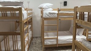 A room with bunk beds, a ceiling fan, and a light fixture. - Hostel City Centre by Janatha (Colombo)