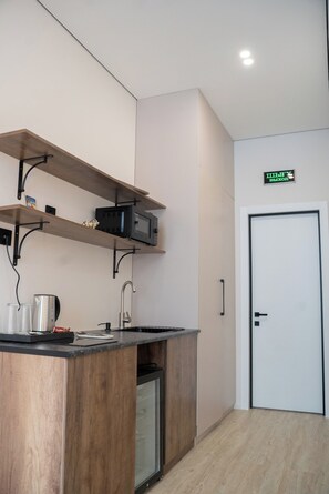 Luxury Suite, Balcony, City View | Private kitchen | Mini-fridge, microwave, electric kettle - SeaStar Boutique Hotel (Almaty)