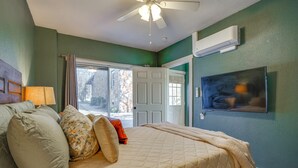 A bedroom with a bed, a ceiling fan, a TV, and a door leading outside. - 'Walnut Creek Retreat' 9 Mi to Decatur Town Square (Decatur)