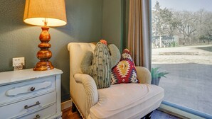 A room with a white sofa, a lamp, a dresser, and a view of a street through a window. - 'Walnut Creek Retreat' 9 Mi to Decatur Town Square (Decatur)