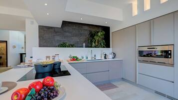 A modern kitchen with a central island, built-in appliances, and a minimalist design.