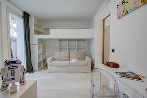 A modern living room with a white sofa, a small table, and a clear glass partition. - Lugano Lake View Villa w. Private Pool (Lugano)