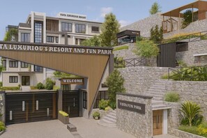 Een moderne resort ingang met een 'Welcome' bord, een 'Vista Luxurious Resort' bord en een 'Vista Fun Park' bord.