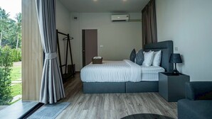 Ein modernes Hotelzimmer mit Bett, Nachttisch und Klimaanlage.