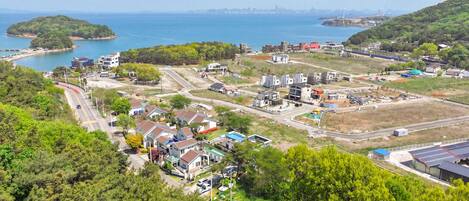 A coastal town with residential houses, a marina, and industrial buildings.