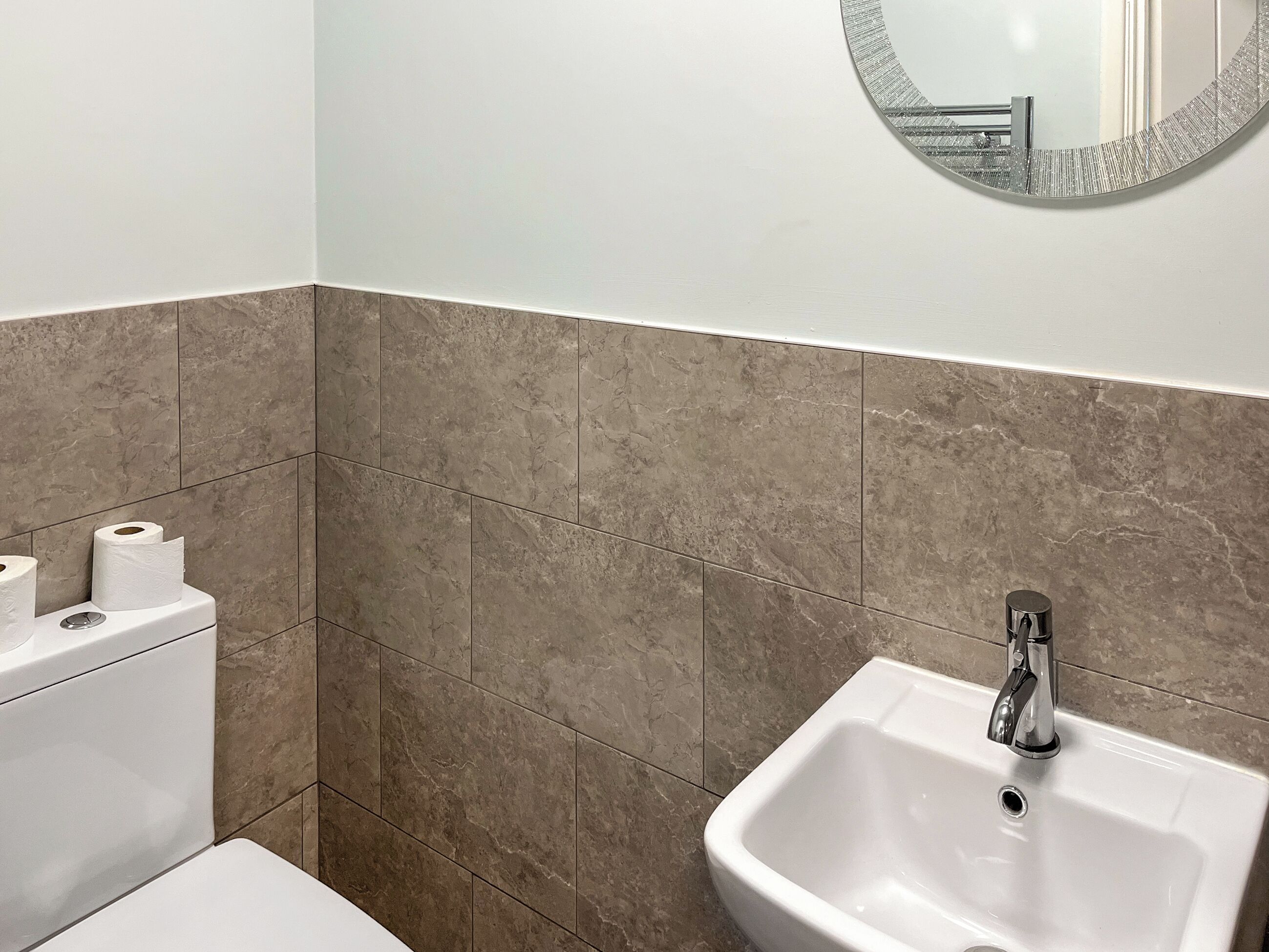 A bathroom with a toilet, bidet, and sink.