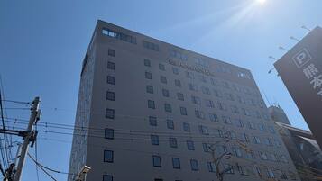 A multi-story building with the name 'AMANEK' prominently displayed on the facade.