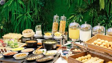 A buffet with various food items and beverages.