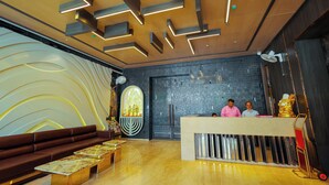 A reception area with a modern design, including a reception desk, seating area, and decorative elements. - Hotel Guru Kripa Grand (3-Star Category)  (Mathura)