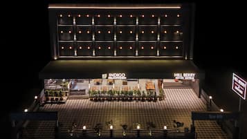 A hotel with a checkered floor, a reception area with a sign, and a wall with lights.