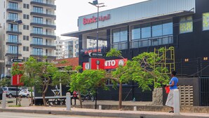 A building with a sign reading 'Basic Nyali' and another sign for 'Big Knife.' - Norden Suites (Mombasa)