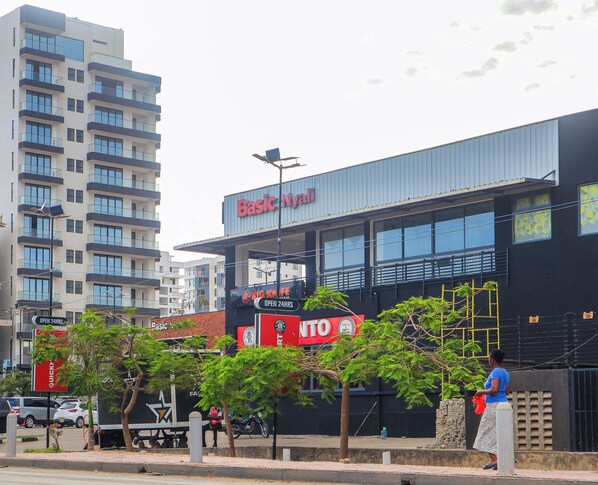 A building with a sign reading 'Basic Nyali' and another sign for 'Big Knife.'