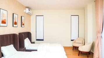 Premium bedding, memory-foam beds, laptop workspace, blackout curtains