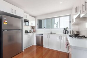 Fridge, microwave, oven, stovetop - Bright 2-Bed Apartment with Balcony & Garage (Five Dock)