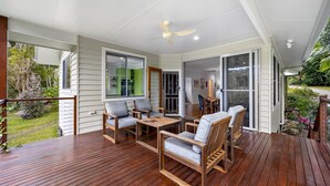 A covered deck with wooden furniture and a ceiling fan. - Quiet Ninderry Cottage with Peaceful Rural Outlook (Ninderry)
