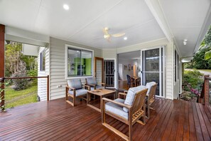 A covered deck with wooden furniture and a ceiling fan. - Quiet Ninderry Cottage with Peaceful Rural Outlook (Ninderry)