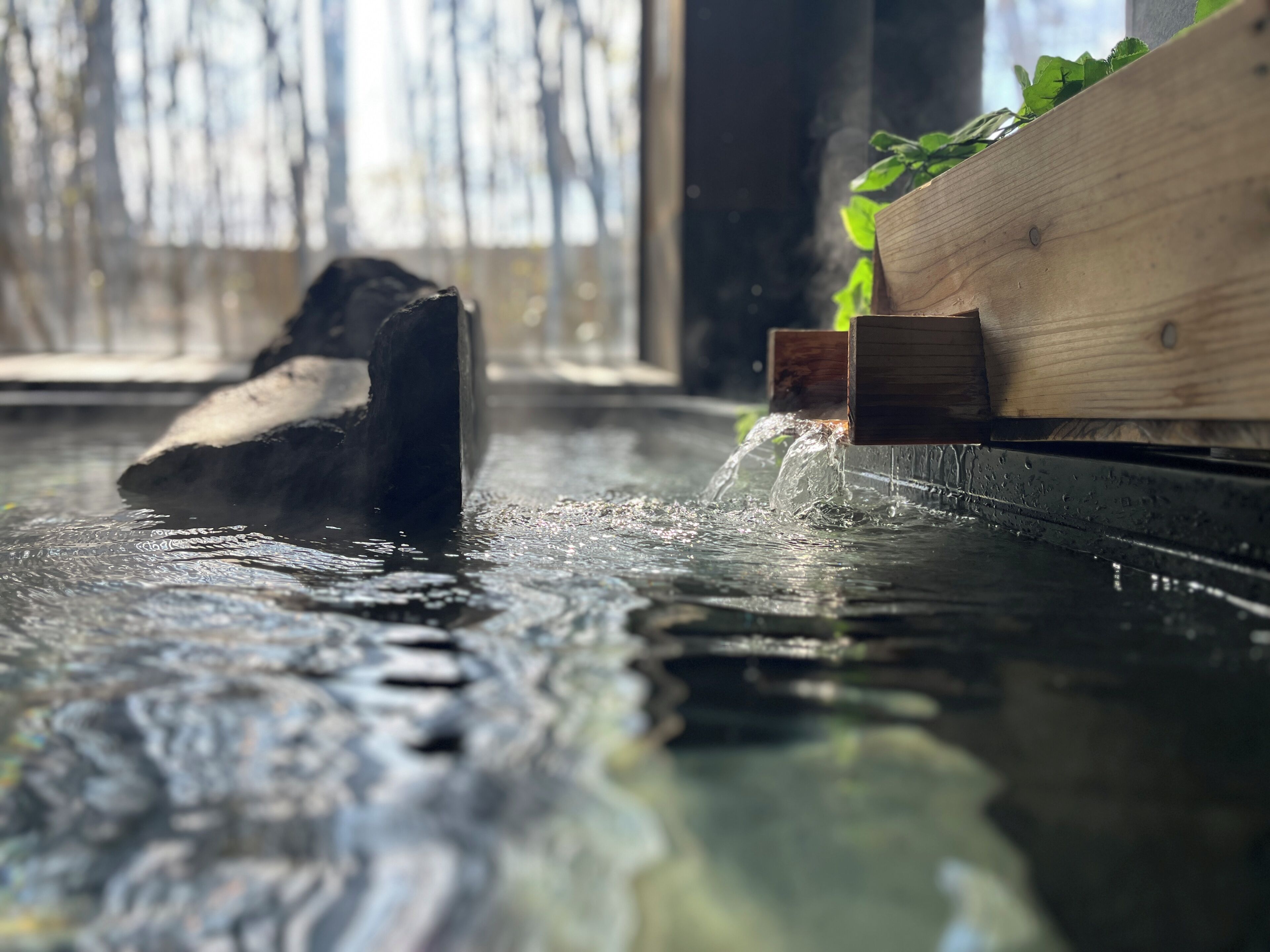A wooden structure partially submerged in water with a wooden platform on the right.