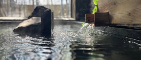 A wooden structure partially submerged in water with a wooden platform on the right.