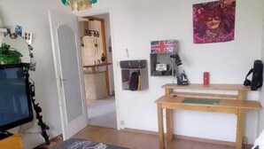 A room with a desk, a chair, a bed, a wardrobe, a mirror, and a door leading to another room. - House 400 m from the beach and port, 5 people (Saint-Michel-Chef-Chef)