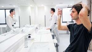A modern bathroom with a large mirror, multiple sinks, and a hairdryer. - Grand Hostel LDK Osaka Shinsekai - Hostel (Osaka)