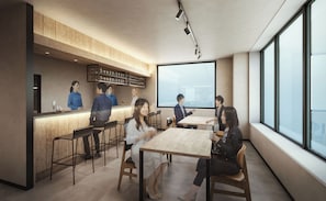 A modern interior with a bar area, seating, and large windows.