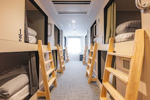 A corridor with bunk beds, wooden ladders, and a tiled floor. - Grand Hostel LDK Osaka Shinsekai - Hostel (Osaka)