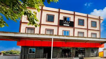 A multi-story building with a sign reading 'Collection & Company Services.'