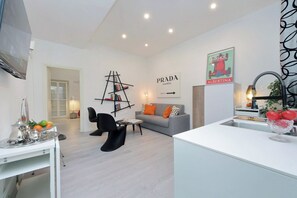 A modern living room with a sofa, coffee table, and a ladder bookshelf. - 2BR 2BA Historic Center, Metro - Comfort, Quiet (Rome)