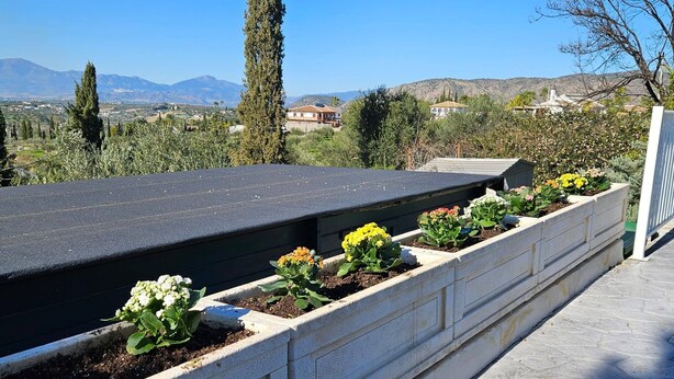 A rooftop garden with flower planters, a view of the countryside, and a clear sky. - Alba NEW I Terrace View & Heated Pool (Alhaurin de la Torre)