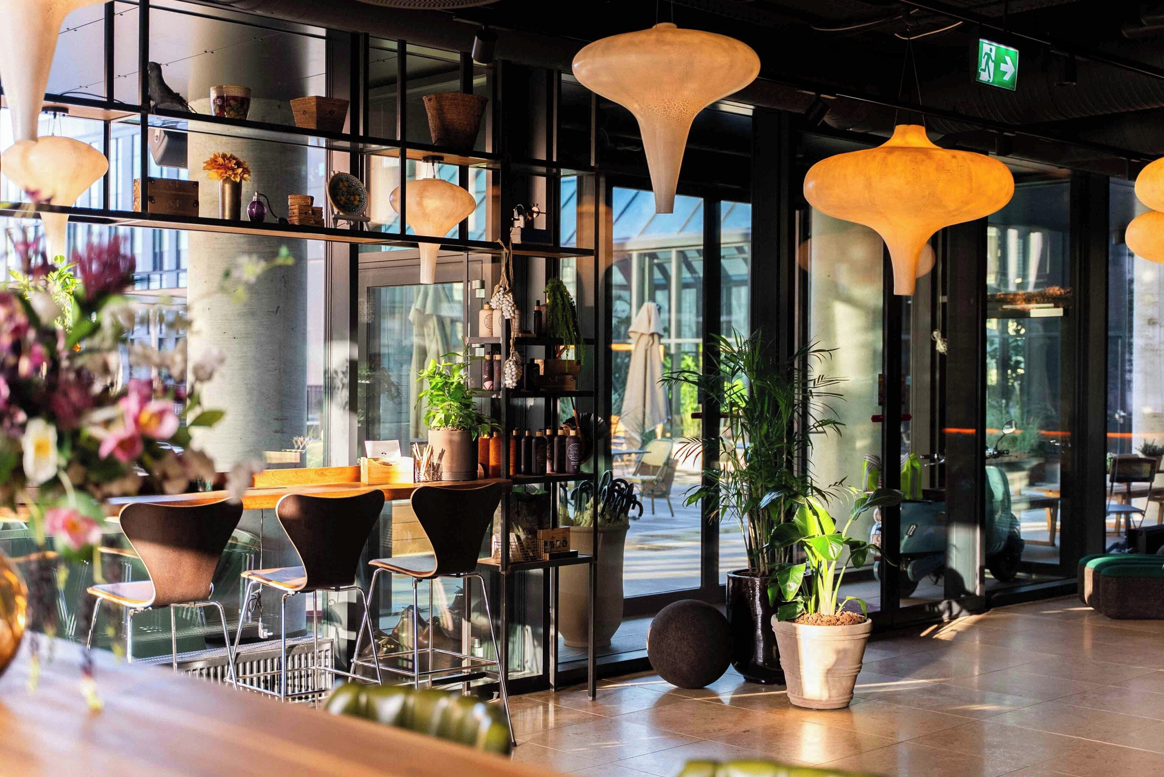 A modern interior with a bar area, seating, and large windows.