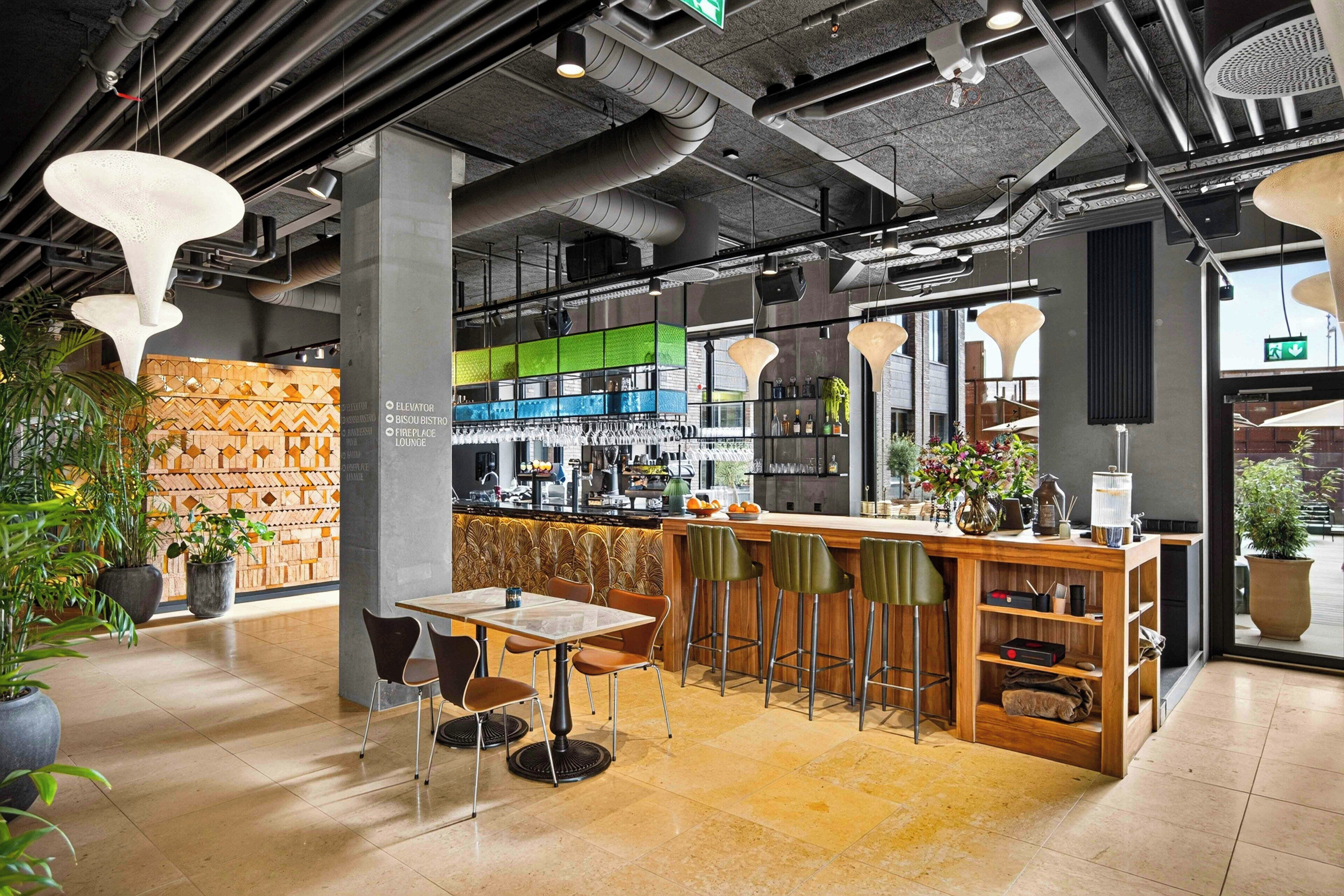 A modern interior with a bar area, seating, and a patterned wall.