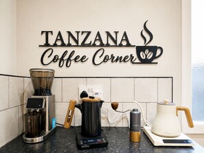 A kitchen with a coffee maker, a kettle, and a coffee grinder. - 3-Bedroom Town Centre House | Sleeps 8 | Self Check-in | Parking | Pet Friendly (St Helens)