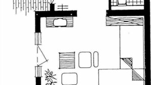 Un plan d’étage d’une chambre d’hôtel comprenant un lit, un bureau, une chaise, une fenêtre et une salle de bain.