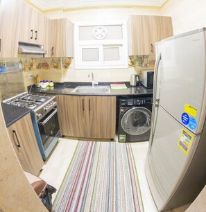 Private kitchen - Designer Suite by Aura: 3BR Luxury & Bespoke Art (Cairo)