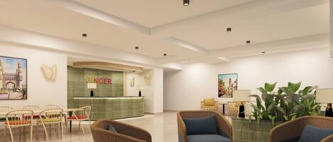 A modern lobby with a reception desk, seating area, and artwork on the walls.