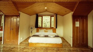 A bedroom with a wooden ceiling, a bed with white bedding, a window with curtains, and a fan. - Royal Stay In The Nature's Lap (Shoghi)