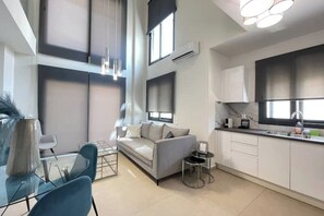 A modern apartment with a living area, kitchen, and dining space. - Athenean Modern Escape near Marina Flisvos-G3 (Paleo Faliro)