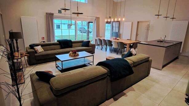 Ein modernes Wohnzimmer mit einer Couch, einem Couchtisch und einem Essbereich.