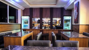 A bar area with seating, a counter, and a refrigerator labeled 'RESTP INT'. - Bengerald Hotel And Suites (Abuja)