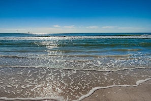 A beach with waves, a clear sky, and distant birds. - Condo 301 - Standard Plus (Sarasota)
