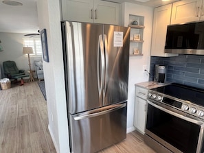 A modern kitchen with stainless steel appliances, a built-in oven, and a microwave. - B04 - Your Oceanfront Oasis Awaits (Sarasota)