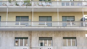 A multi-story building with balconies, windows with shutters, and a concrete facade. - Albaro Sun House by Wonderful Italy (Genova)