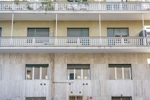 A multi-story building with balconies, windows with shutters, and a concrete facade. - Albaro Sun House by Wonderful Italy (Genova)
