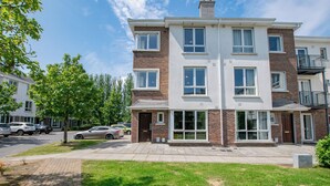 A multi-story residential building with a brick facade, large windows, and a flat roof. - The Townhouse by Shortstays (Galway)