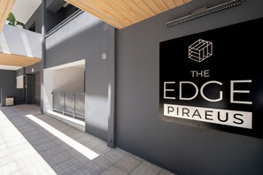 A modern building with a sign reading 'THE EDGE PIRAEOUS'.