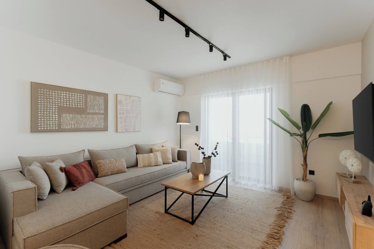 A modern living room with a sofa, coffee table, and decorative items.
