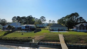 A residential area with houses, a swimming pool, and a wooden dock. - Stunning Mobile Bay views near Dauphin Island (Coden)