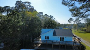 A house with a sloped roof, a balcony, and a deck. - Stunning Mobile Bay views near Dauphin Island (Coden)