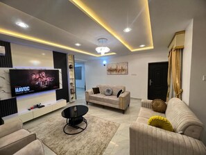 Departamento Deluxe, balcón, vista a la ciudad | Área de sala de estar