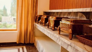 A marble shelf with wicker baskets and wooden boxes. - Hotel Walnut Ladakh (Leh)